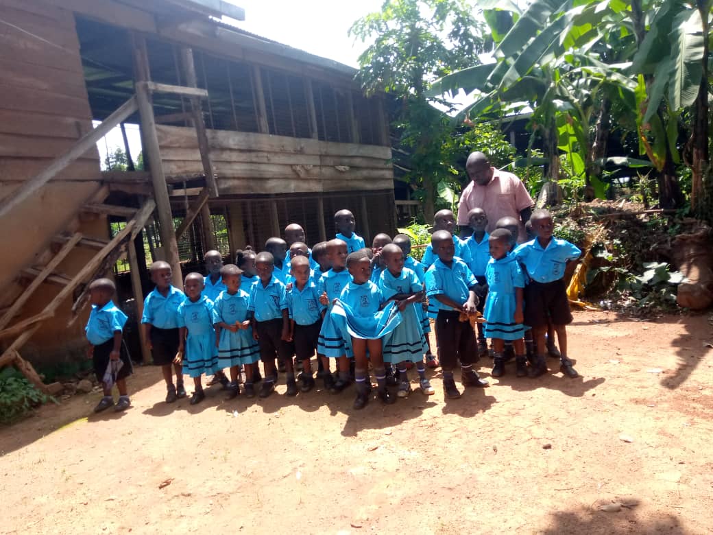 Pupils lined up outside the centre building with their teachers